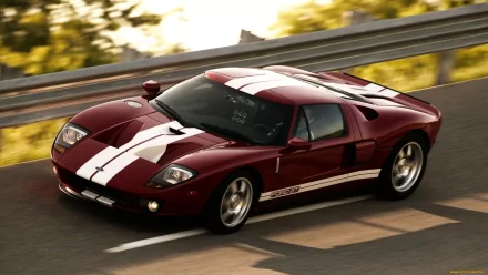 HD PC desktop wallpaper featuring a red Ford GT sports car with white racing stripes driving on a sunlit road.
