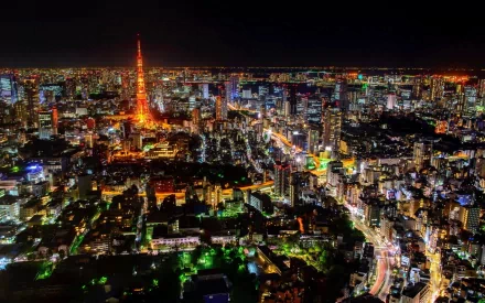 Nighttime cityscape of Tokyo, Japan, featuring the illuminated Tokyo Tower amidst a sprawling urban landscape. HD desktop wallpaper showcasing man-made city lights.