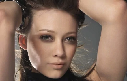 HD PC desktop wallpaper featuring a close-up portrait of celebrity Hilary Duff with soft lighting and a neutral background.