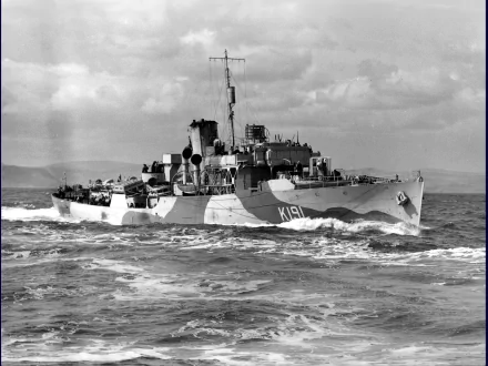 Black and white HD wallpaper of the Canadian Navy corvette HMCS Mayflower (K191) sailing through choppy waters under a cloudy sky.