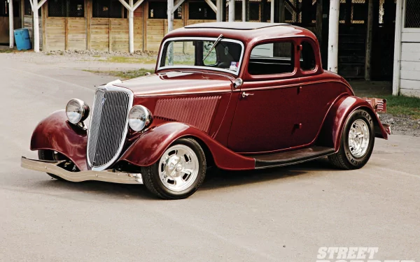 A classic 1933 Ford Coupe in deep red, captured in high definition as a PC desktop wallpaper, showcasing vintage design and polished chrome details.