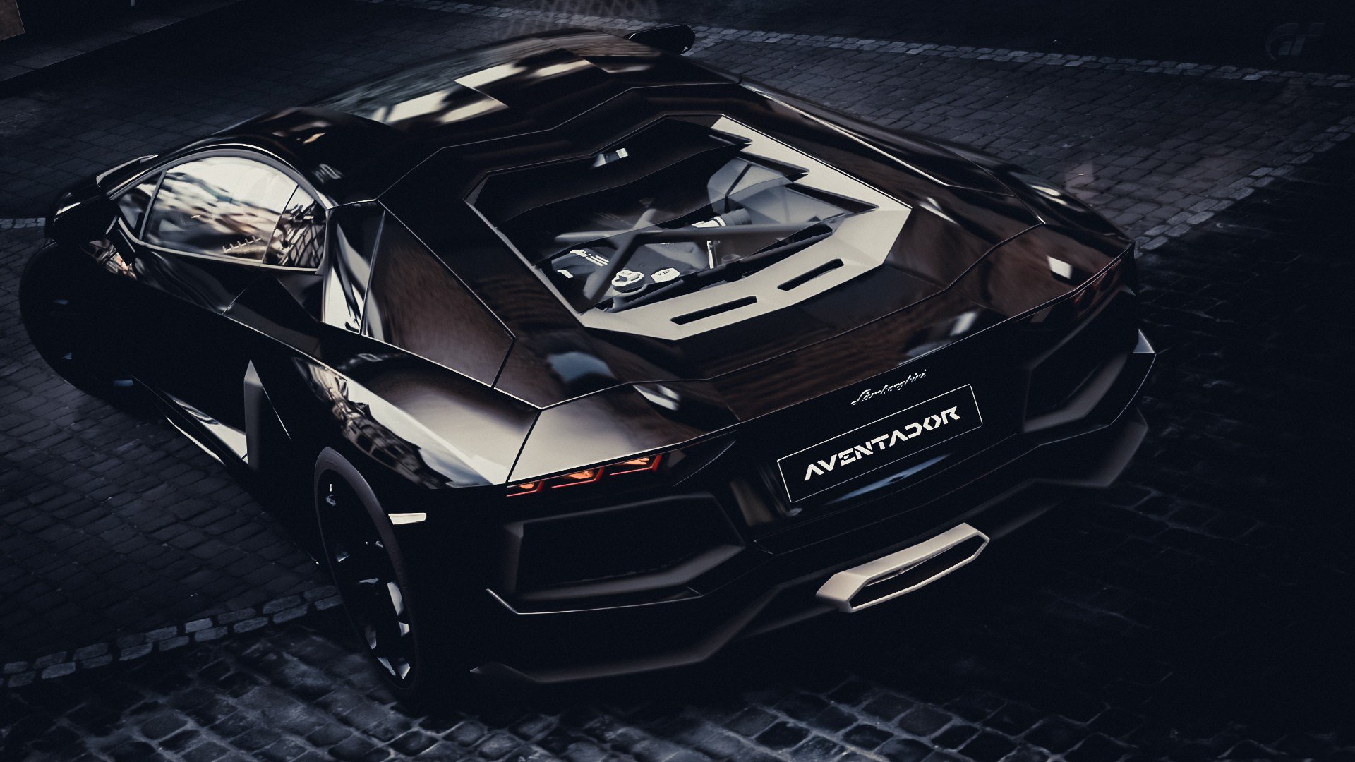 HD desktop wallpaper featuring a sleek black Lamborghini Aventador parked on a cobblestone street under low light.