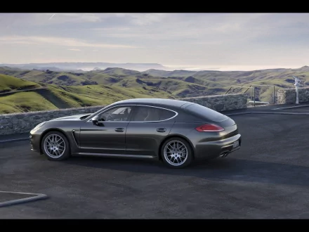 Sleek Porsche Panamera showcased on a mountain road at dusk, captured in an HD PC desktop wallpaper featuring the luxury car and scenic landscape.