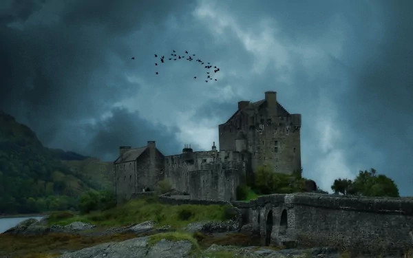 Eilean Donan Castle stands majestically against a dramatic sky, surrounded by lush greenery and rocky terrain, creating an enchanting backdrop for this HD desktop wallpaper.