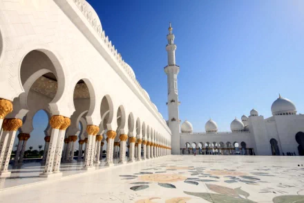 A stunning view of the Sheikh Zayed Grand Mosque in Abu Dhabi, showcasing its intricate architecture and serene atmosphere under a clear blue sky.