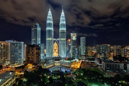 A stunning HD wallpaper of the iconic Petronas Towers in Kuala Lumpur, Malaysia, showcasing their impressive architecture against a vibrant night skyline.