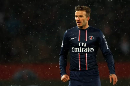 David Beckham in a Paris Saint-Germain jersey on the field, captured in high definition. The image serves as a sports-themed desktop wallpaper and background.