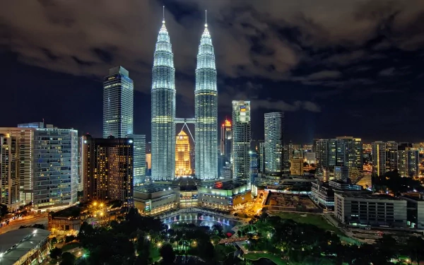 A stunning HD wallpaper of the iconic Petronas Towers in Kuala Lumpur, Malaysia, showcasing their impressive architecture against a vibrant night skyline.