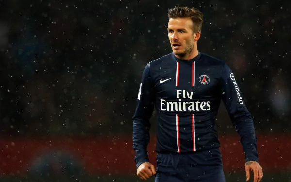 David Beckham in a Paris Saint-Germain jersey on the field, captured in high definition. The image serves as a sports-themed desktop wallpaper and background.