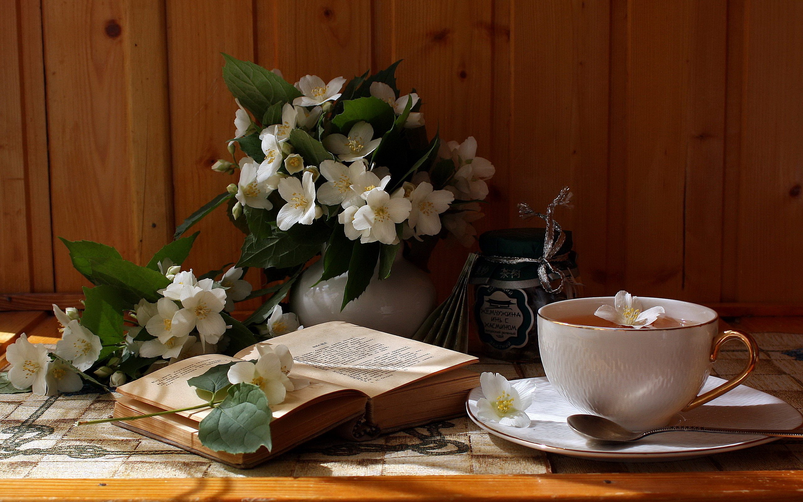 Cozy Tea Moments: HD Wallpaper of Flowers, Book, and Warm Cup