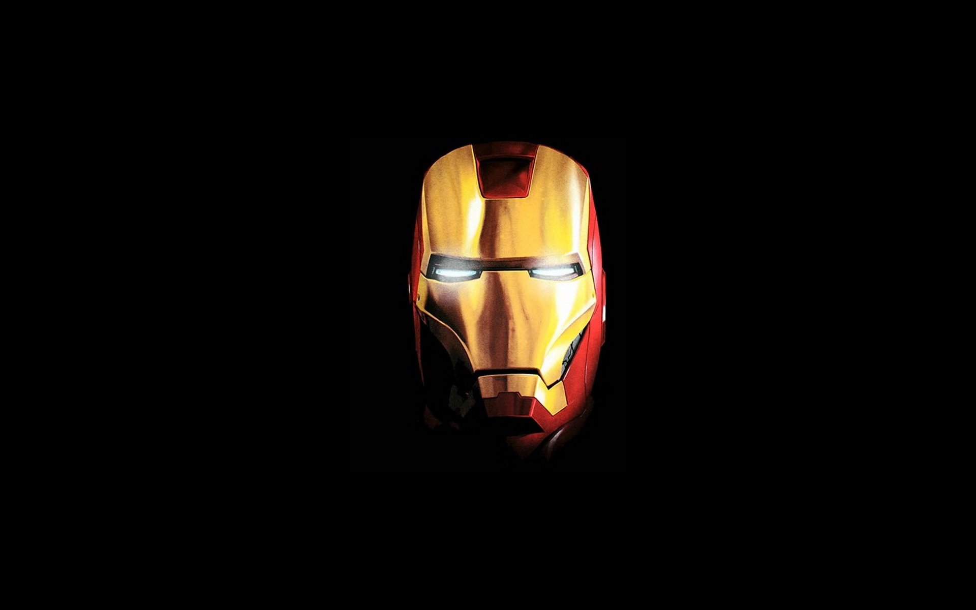 HD PC desktop wallpaper featuring the glowing mask of Iron Man from the movie, set against a black background for a dramatic effect.