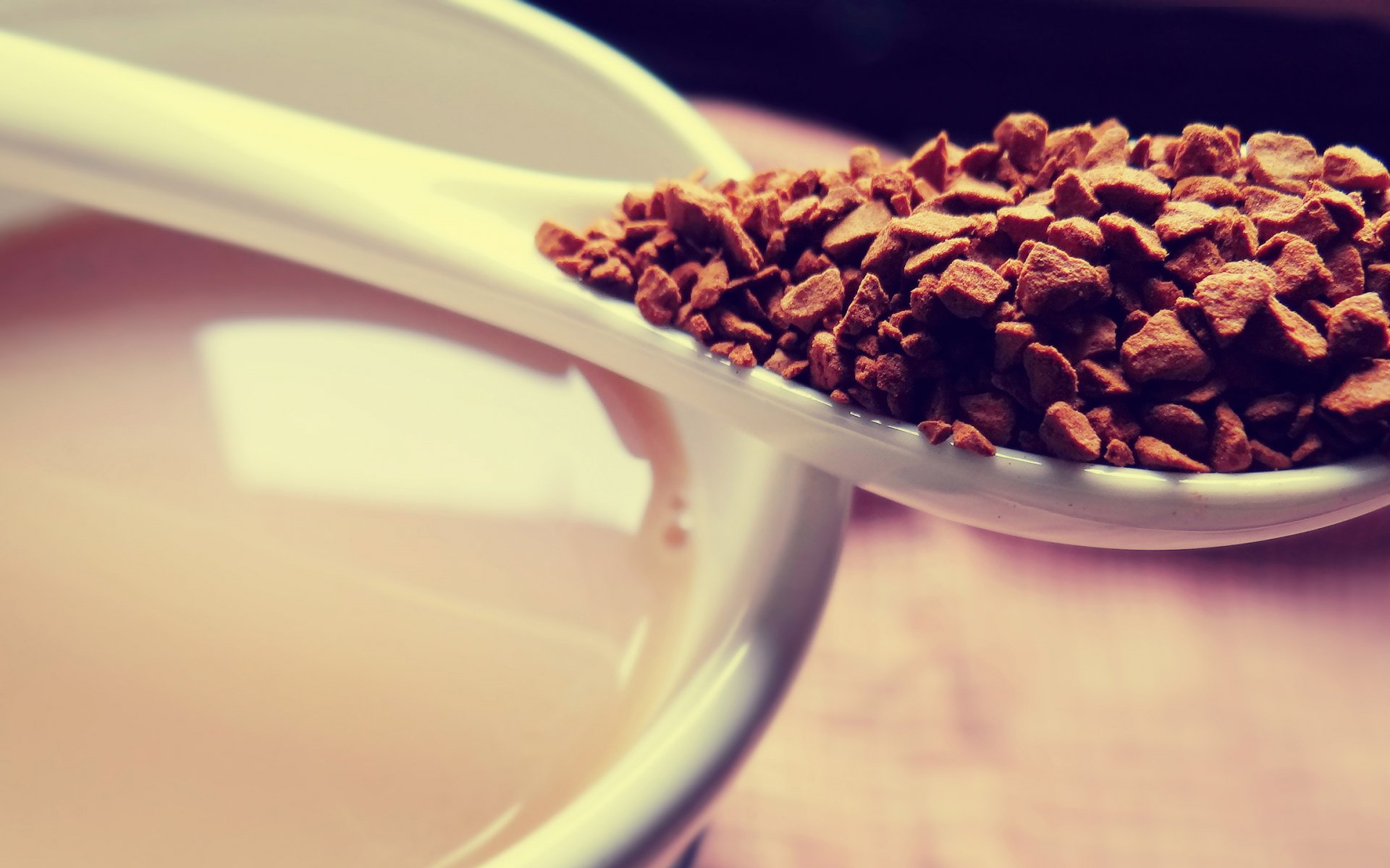 Close-up of a spoonful of instant coffee granules above a cup of brewed coffee, captured as an HD PC desktop wallpaper and background.