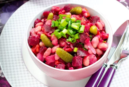 HD PC desktop wallpaper showing a vibrant bowl of salad with beans, pickles, beets, and chopped green onions on a white plate with cutlery.