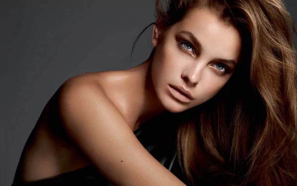 A striking HD desktop wallpaper featuring celebrity Barbara Palvin, showcasing her captivating expression and flowing hair against a dark background.