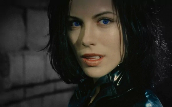 HD PC desktop wallpaper featuring a close-up of a female character from the movie Underworld: Evolution with striking blue eyes and dark hair.