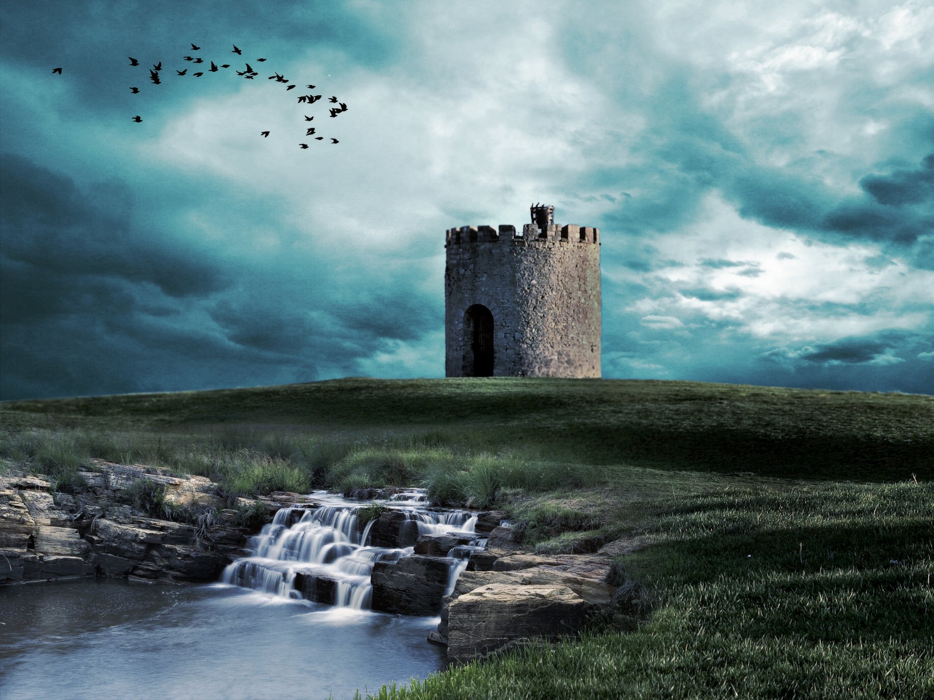 HD landscape photography of a solitary stone tower on a grassy hill under a dramatic cloudy sky, with a small waterfall and birds in flight, captured as a PC desktop wallpaper.