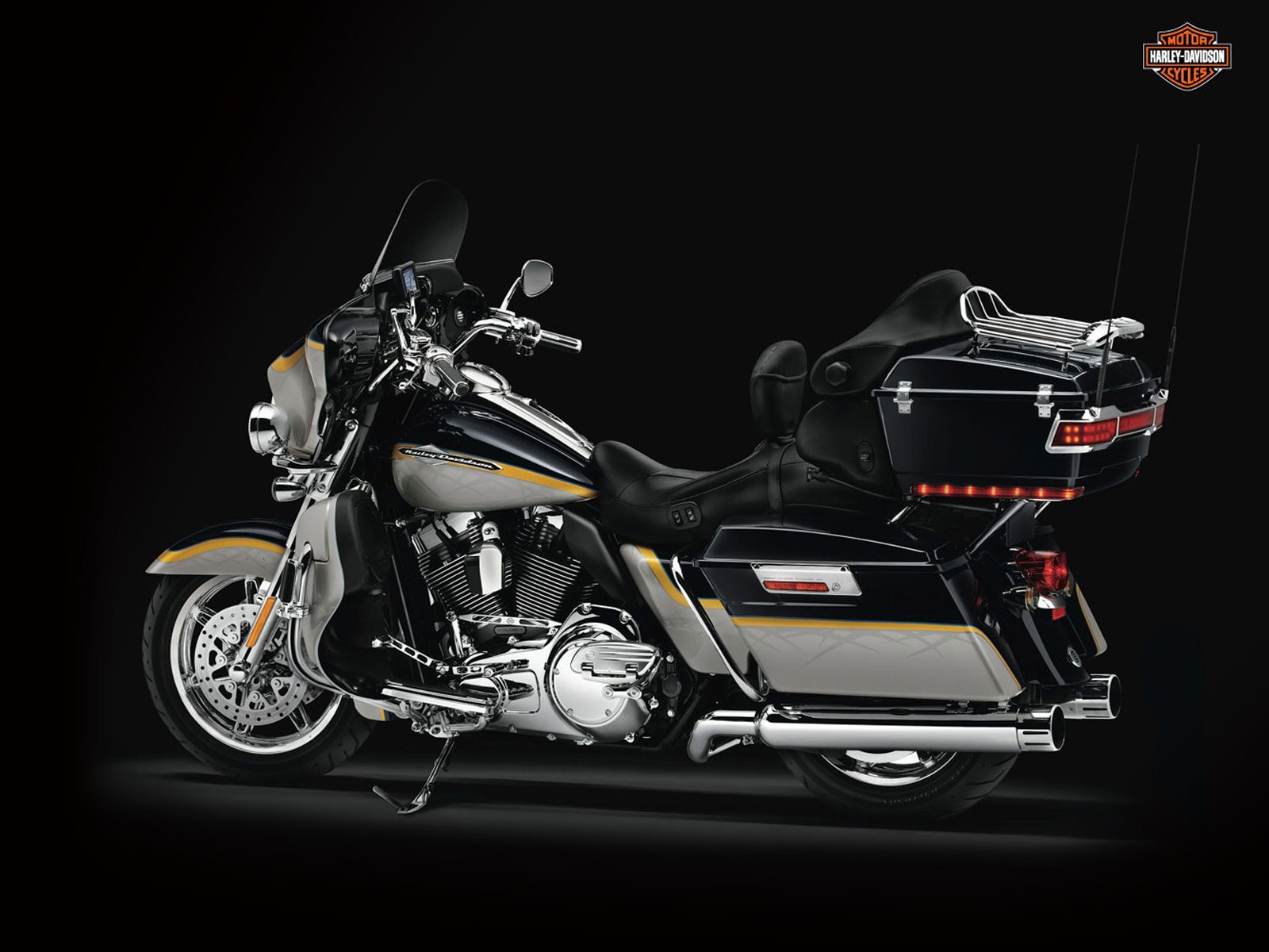 A sleek Harley-Davidson motorcycle, prominently featured against a dark background, showcases its polished design, making it an impressive HD PC desktop wallpaper and background.