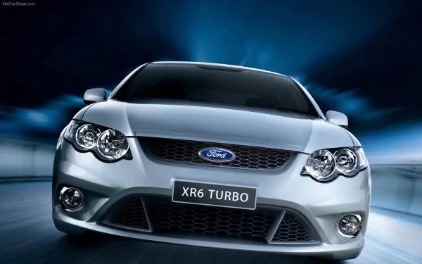 Front-facing silver Ford FG Falcon XR6 Turbo against a blue motion-blur background, rendered as a 2K Quad HD PC desktop wallpaper.