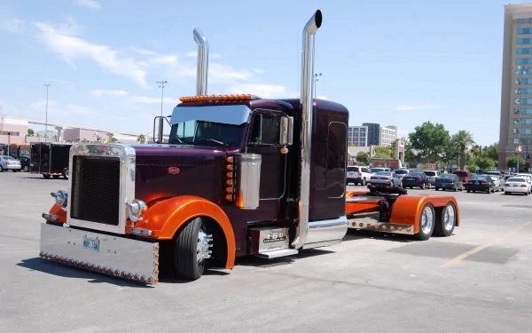 A detailed Peterbilt truck parked in an urban lot, captured in 4K Ultra HD as a high-resolution PC desktop wallpaper and background.