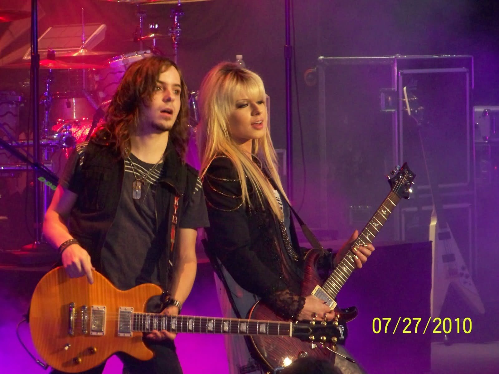 HD PC desktop wallpaper featuring musicians playing guitars on stage, tagged with music and Orianthi.