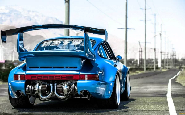 HD desktop wallpaper featuring the rear view of a blue Porsche on a road with power lines in the background.