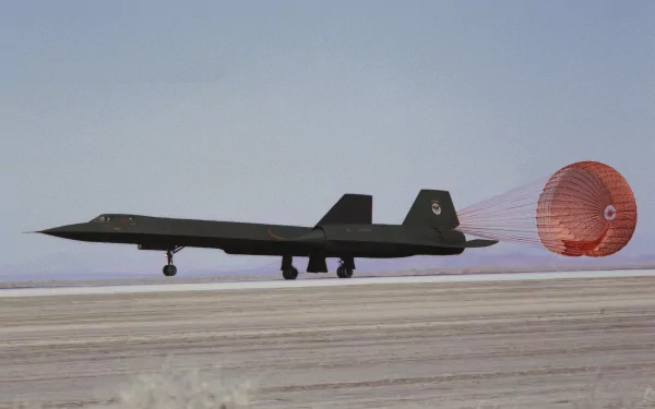 HD desktop wallpaper featuring a Lockheed SR-71 Blackbird military aircraft landing with its drag chute deployed on the runway.