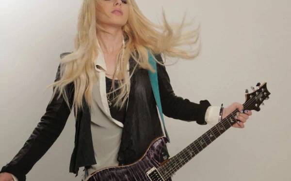 HD PC desktop wallpaper featuring Orianthi playing an electric guitar, capturing her dynamic presence in music.