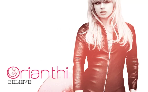 HD desktop wallpaper featuring musician Orianthi in a red leather jacket with the word Believe and her name in stylized text on a white background.