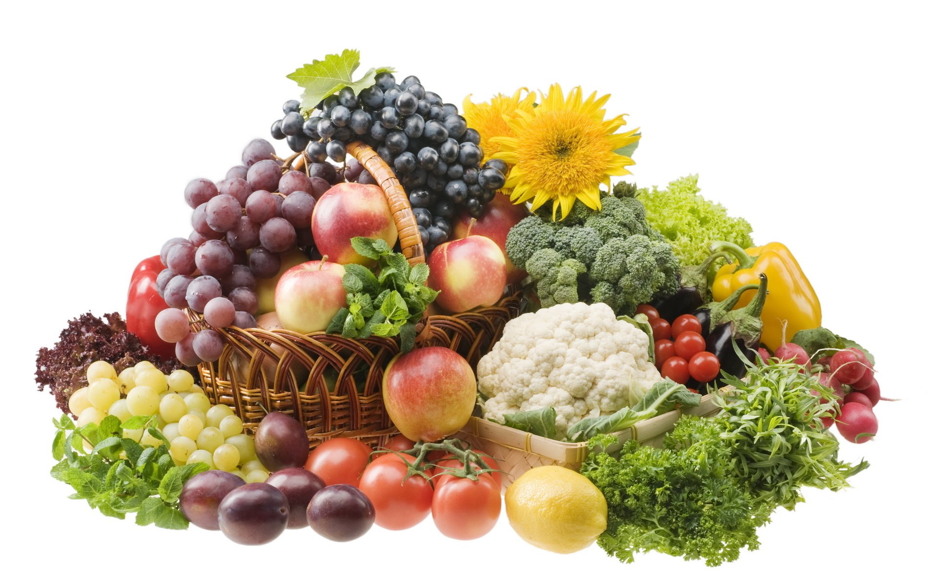 A vibrant still life of fresh fruits and vegetables, featuring grapes, apples, broccoli, tomatoes, and sunflowers, creating a colorful array for a high-definition desktop background.