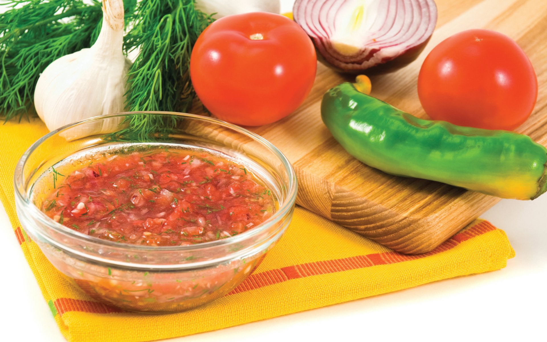 HD PC desktop wallpaper featuring fresh ingredients including tomatoes, garlic, dill, onion, and a green chili pepper alongside a bowl of vibrant red soup.