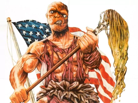 HD PC desktop wallpaper background: movie image of The Toxic Avenger clutching a sludge-soaked mop in front of a tattered American flag.
