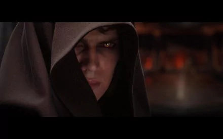 HD desktop wallpaper of Hayden Christensen as Anakin Skywalker in Star Wars Episode III: Revenge of the Sith. Anakin is shown wearing a hooded cloak and staring intensely.