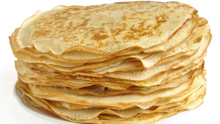 Stack of golden-brown crêpes displayed in high definition, designed as a PC desktop wallpaper and background showcasing delicious food.