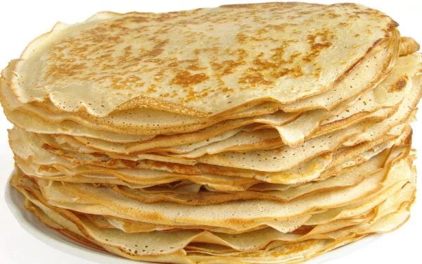 Stack of golden-brown crêpes displayed in high definition, designed as a PC desktop wallpaper and background showcasing delicious food.