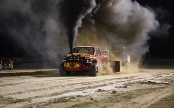 Smoky night shot of a vehicle — a truck racing down a dirt track, kicking up dust and black exhaust; 4K Ultra HD PC Desktop Wallpaper and Background.
