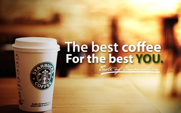 HD PC desktop wallpaper showing a Starbucks paper cup on a wooden table with a warm, blurred bokeh background and overlaid text The best coffee For the best YOU. (food, man-made)