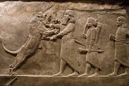Artistic HD PC desktop wallpaper depicting an ancient Assyrian lion hunt carved in detailed stone relief.