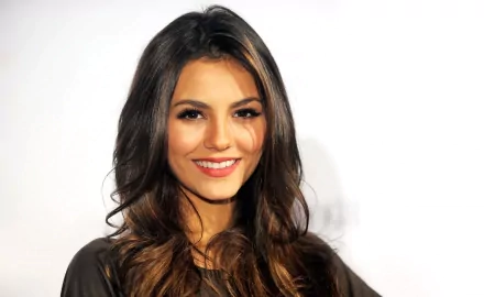 HD desktop wallpaper featuring Victoria Justice, showcasing her warm smile and flowing hair against a clean background. A vibrant addition to any screen.