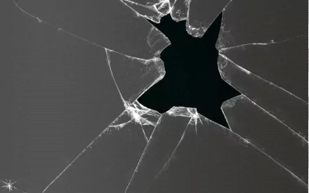 Abstract broken glass design featuring jagged edges and a dark void, creating a striking visual. This HD image serves as a dynamic desktop wallpaper or background.