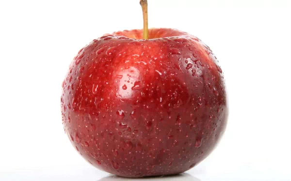 Close-up red apple with water droplets on white background — food apple image rendered as a 2K Quad HD PC desktop wallpaper and background.
