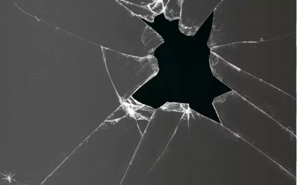 Abstract broken glass design featuring jagged edges and a dark void, creating a striking visual. This HD image serves as a dynamic desktop wallpaper or background.