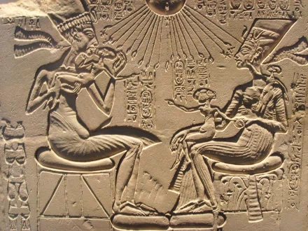 Intricate Egyptian artwork depicting figures seated, surrounded by hieroglyphs and radiating light, showcased as a high-definition PC desktop wallpaper and background.