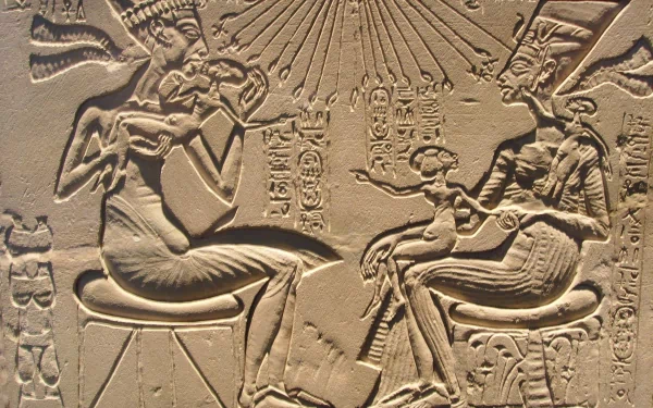 Intricate Egyptian artwork depicting figures seated, surrounded by hieroglyphs and radiating light, showcased as a high-definition PC desktop wallpaper and background.
