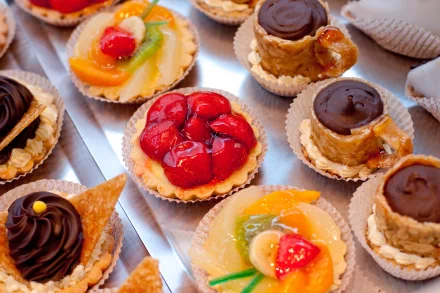 A vibrant display of assorted desserts, featuring fruit tarts and chocolate confections, presented beautifully as an HD desktop wallpaper and background.