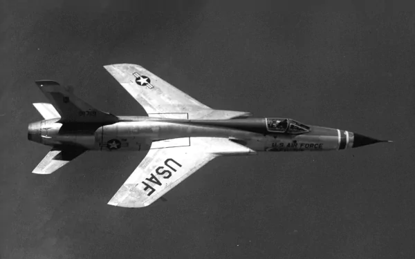 Black and white HD desktop wallpaper showing a Republic F-105 Thunderchief military aircraft in flight against a dark sky background.