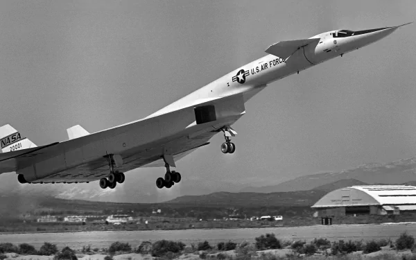 Black-and-white military North American XB-70 Valkyrie taking off over a runway — 2K Quad HD PC desktop wallpaper and background image.