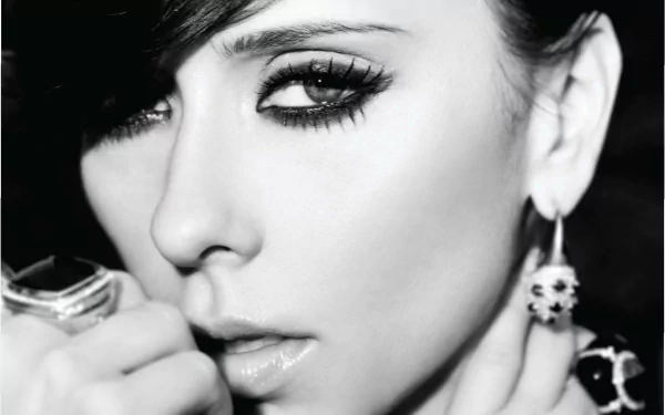 Close-up black and white HD desktop wallpaper of celebrity Jennifer Love Hewitt, highlighting her eyes and hand adorned with rings and earrings.