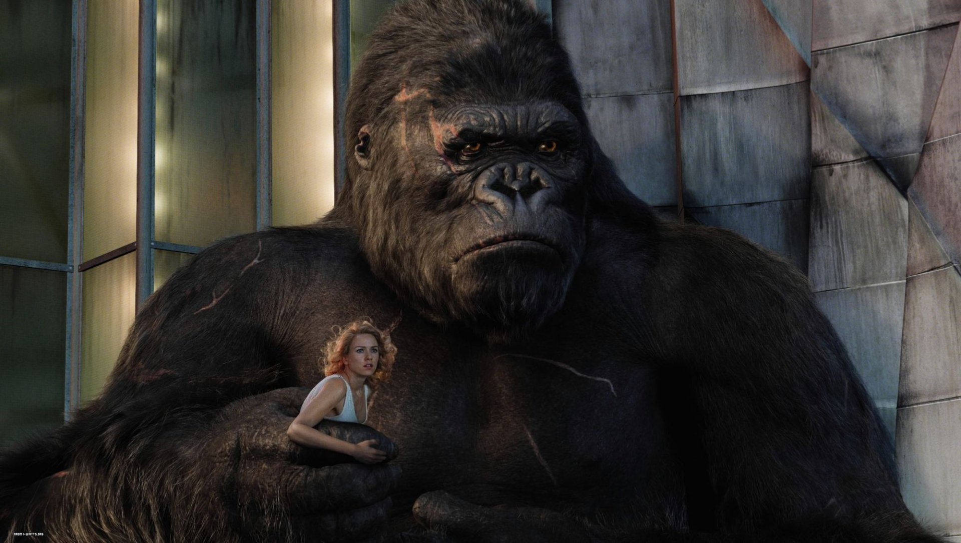 A dramatic scene from the movie King Kong (2005) featuring the iconic ape alongside a woman, set against a modern urban backdrop, showcasing intense emotion and grandeur.