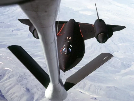 High-definition desktop wallpaper featuring the Lockheed SR-71 Blackbird, a sleek military reconnaissance aircraft captured mid-flight from above.