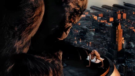 A striking HD wallpaper from the 2005 movie King Kong, featuring the iconic giant gorilla looming over a cityscape, with a woman perched nearby, capturing a dramatic moment.